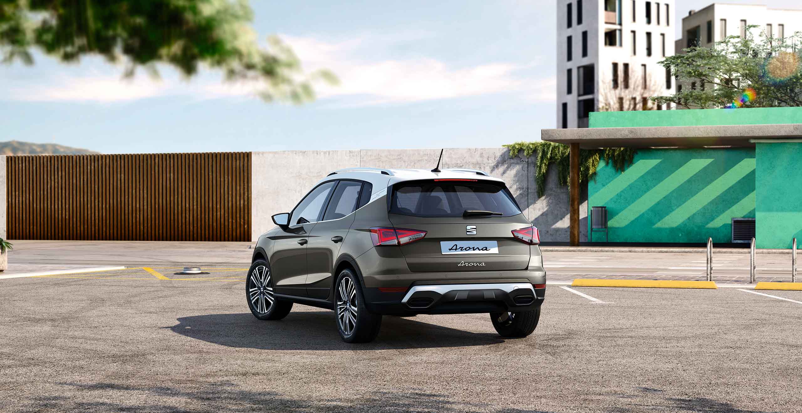 Woman leaning on front grille SEAT Arona dark camouflage colour with white roof