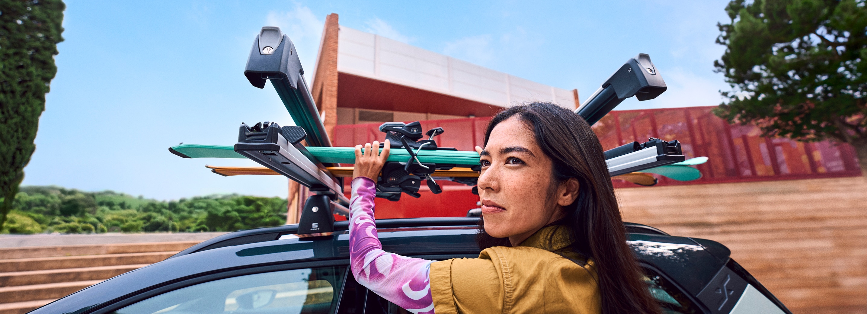 SEAT Arona equipped with ski rack carrying skis outdoors